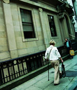 a women with a cane walking down the street