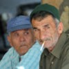 Two older men smoking cigarettes