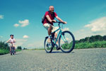 father and child riding bicyles