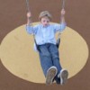 child playing on a swing