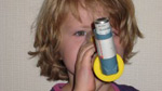 a child using an asthma inhaler