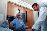a patient meeting with his doctor in the hospital recovery room