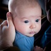 an infant being held by his parent