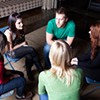 teenagers sitting in a group discussing personal issues