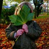 a young child outdoors hiding her face