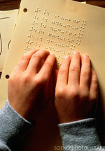 boy reading using braille