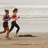 females jogging on the beach